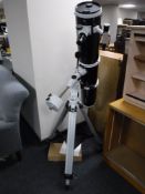 A Skywatcher reflector telescope on stand with instructions and a box containing Barlow lenses