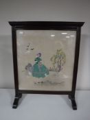 A mahogany tapestry fire screen