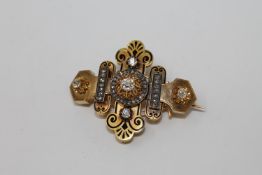 A superb quality gold and enamel diamond brooch, the central stone approximately 0.7ct, 21.