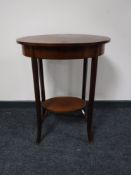 An early 20th century oval mahogany sewing table