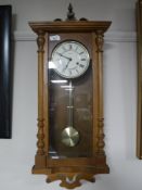 A Hermle oak wall clock