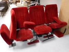 Four mid 20th century cinema seats upholstered in a red fabric