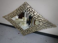 A contemporary diamond shaped bevel edged overmantel mirror