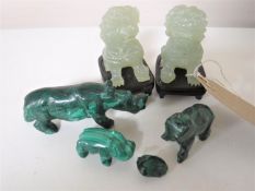 A pair of jade foo dogs on wooden stands, height 6cm,
