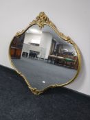 An ornate gilt metal framed mirror