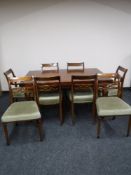 A reproduction mahogany dining table and six chairs (4 + 2)