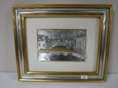 A relief plaque modelled as a view along a river with bridge, framed, stamped .800.