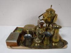 A tray containing assorted brass ware including a spirit kettle on stand, measures,
