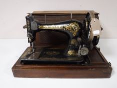 A mid twentieth century mahogany cased Singer hand sewing machine