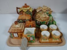 A tray containing cottage ware china