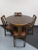 An oak extending dining table and four chairs