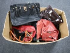 A box containing a quantity of lady's leather handbags