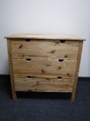 A pine three drawer chest
