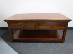 A hardwood two tier coffee table fitted two drawers