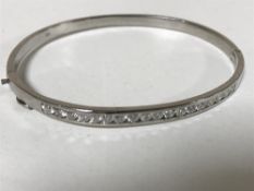 A 14ct gold diamond set bangle, 11.8g.