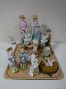 A tray containing continental figurines, including cherub with cello, cherub candlestick holder,