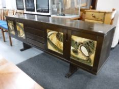 A late 20th century long john sideboard with tiled panel door inserts