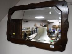 An Edwardian oak framed bevel edged mirror