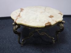 A shaped onyx coffee table on brass base