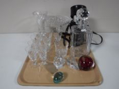 A tray containing glass paperweights, etched glass whiskey decanter,