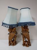 A pair of carved hardwood table lamps with shades