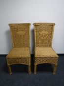 A pair of wicker high back dining chairs