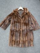 A 3/4 length fur coat with hat