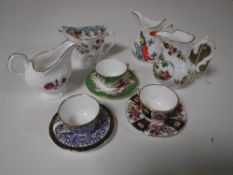 Four Royal Worcester milk jugs and three Royal Worcester miniature cups and saucers