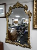 An ornate gilt wood hall mirror