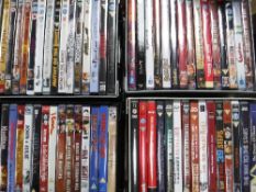 Five small storage boxes with lids containing DVDs