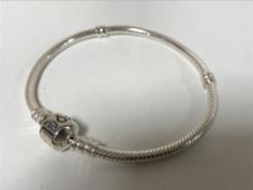 A sterling silver Pandora bracelet, in box with receipt.
