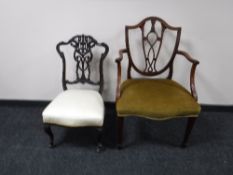 An antique mahogany shield back chair and a carved mahogany bedroom chair