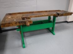 A mid 20th century wooden work bench CONDITION REPORT: This measures 235cm long,