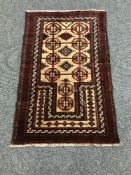An Afghan rug on red ground,