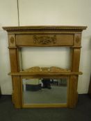 A carved oak fire surround with over mantel mirror