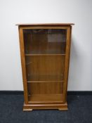 A teak glazed door display cabinet