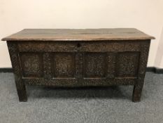 An eighteenth century carved oak coffer,