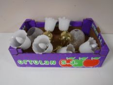 A box containing two brass three way light fittings, with glass shades,