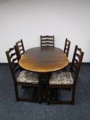 An oval oak extending table and five ladder back chairs