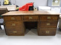 A antique pine seven drawer knee hole desk