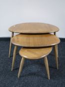 A nest of three Ercol elm pebble tables
