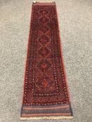 A Persian runner on red ground,