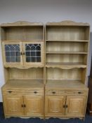 A 20th century blonde oak twin section bookcase fitted cupboards beneath