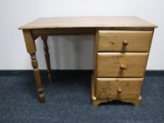 A pine dressing table fitted three drawers