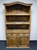 A Mexican pine shaped topped bookcase