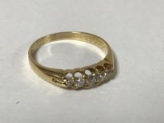 An 18ct gold five stone diamond ring, size O, 2.7g.