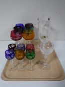 A tray containing a set of six German coloured cut glass wine glasses with matching liqueur glasses,