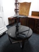 A late twentieth century circular rosewood effect smoked glass topped coffee table,