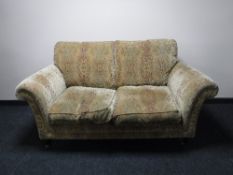 A Parker Knoll two seater settee in a floral fabric