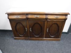 A narrow triple door and marble topped sideboard